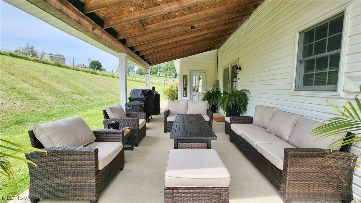View of patio with an outdoor living space and grilling area