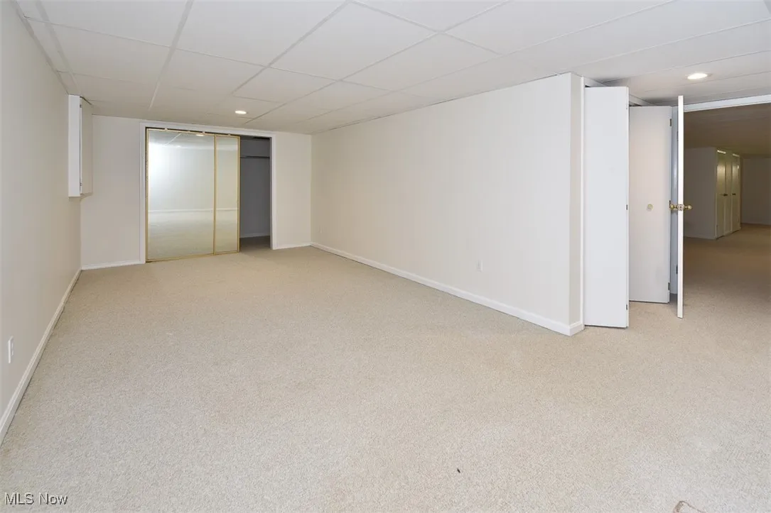 Finished below grade area with light carpet and a drop ceiling