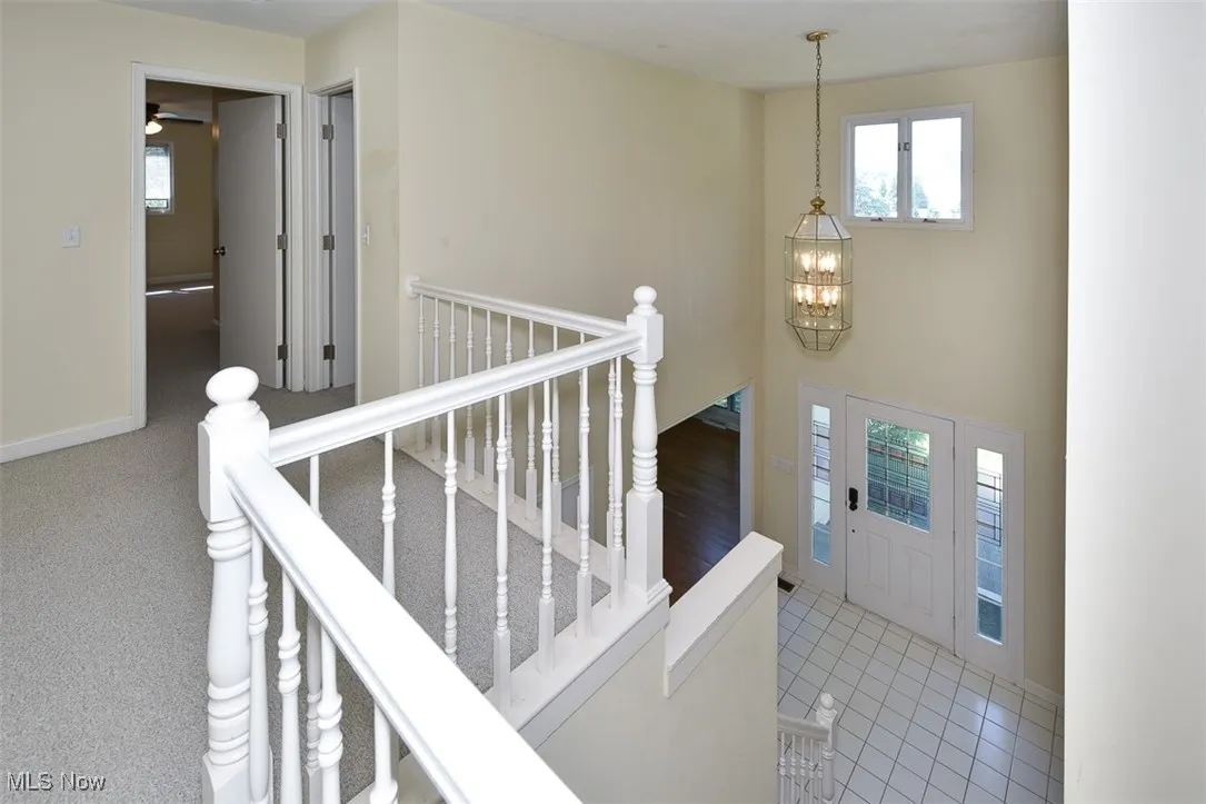 Foyer entrance with a chandelier and tile patterned floors