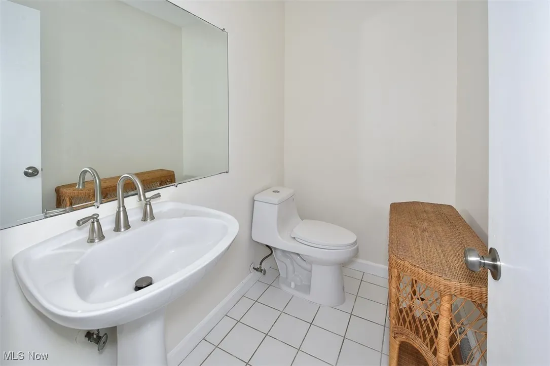 Bathroom with baseboards and tile patterned floors