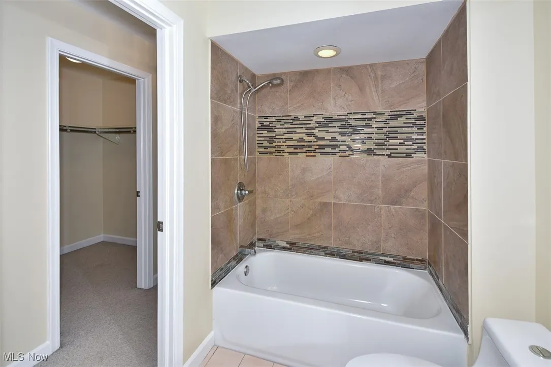 Bathroom with toilet and tub / shower combination