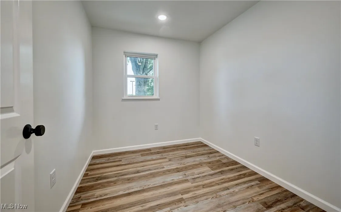 Empty room featuring wood finished floors and recessed lighting