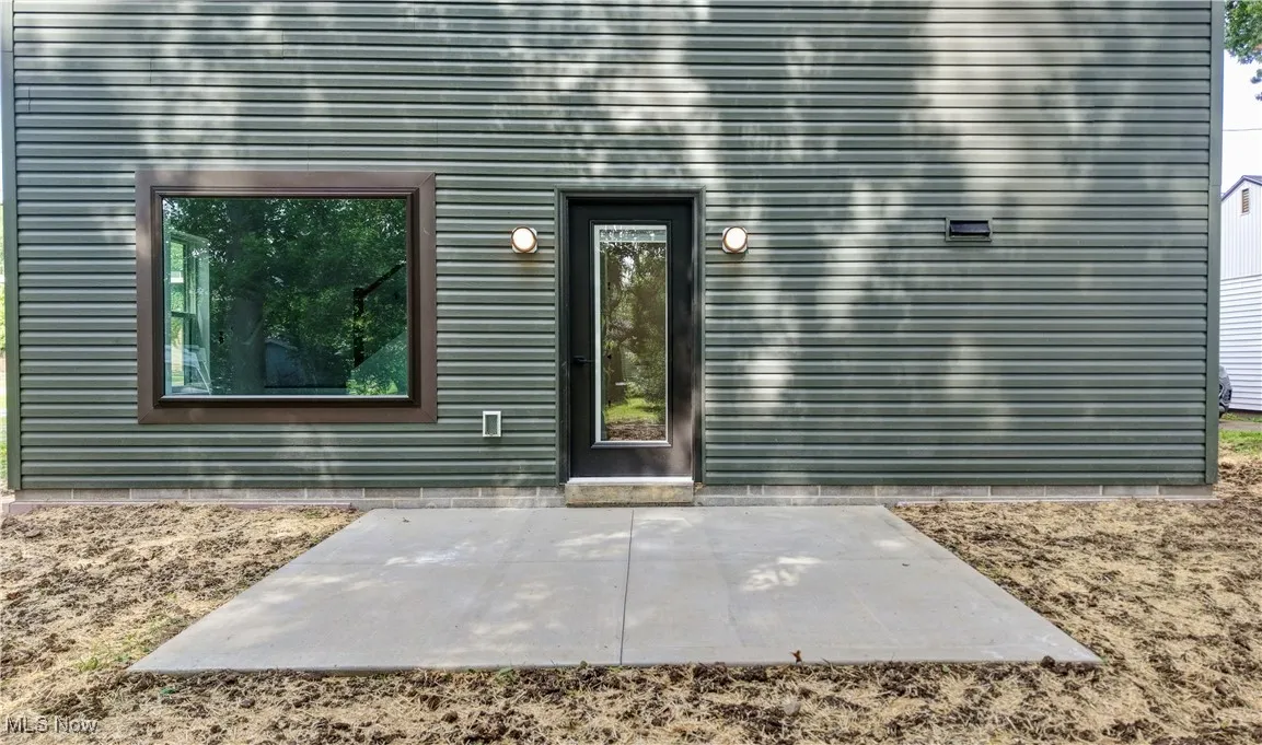 Doorway to property featuring a patio area