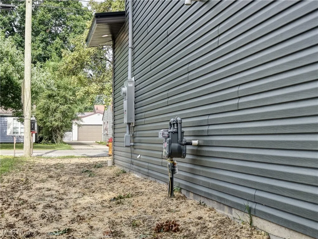 View of side of property with an outdoor structure and a garage