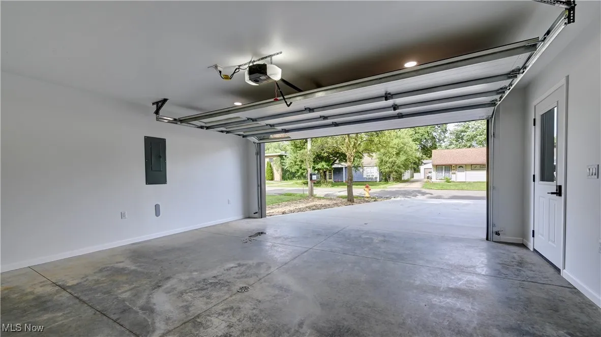 Garage with electric panel and a garage door opener