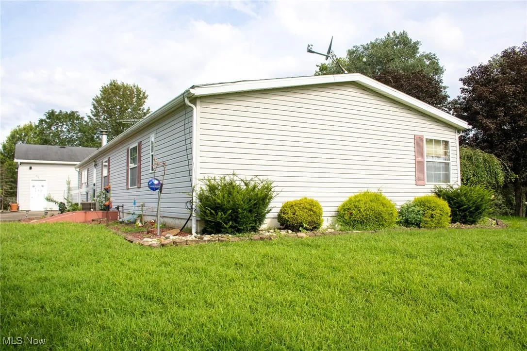 View of property exterior featuring a yard