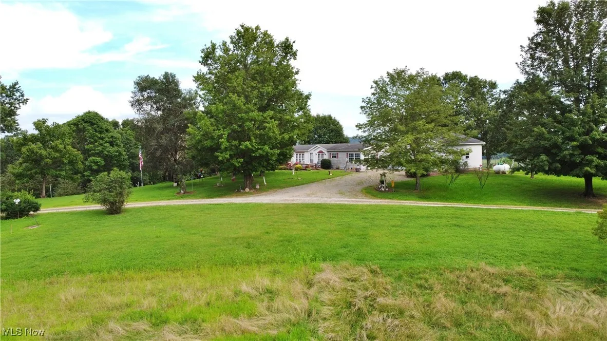 Surrounding community with driveway and a yard
