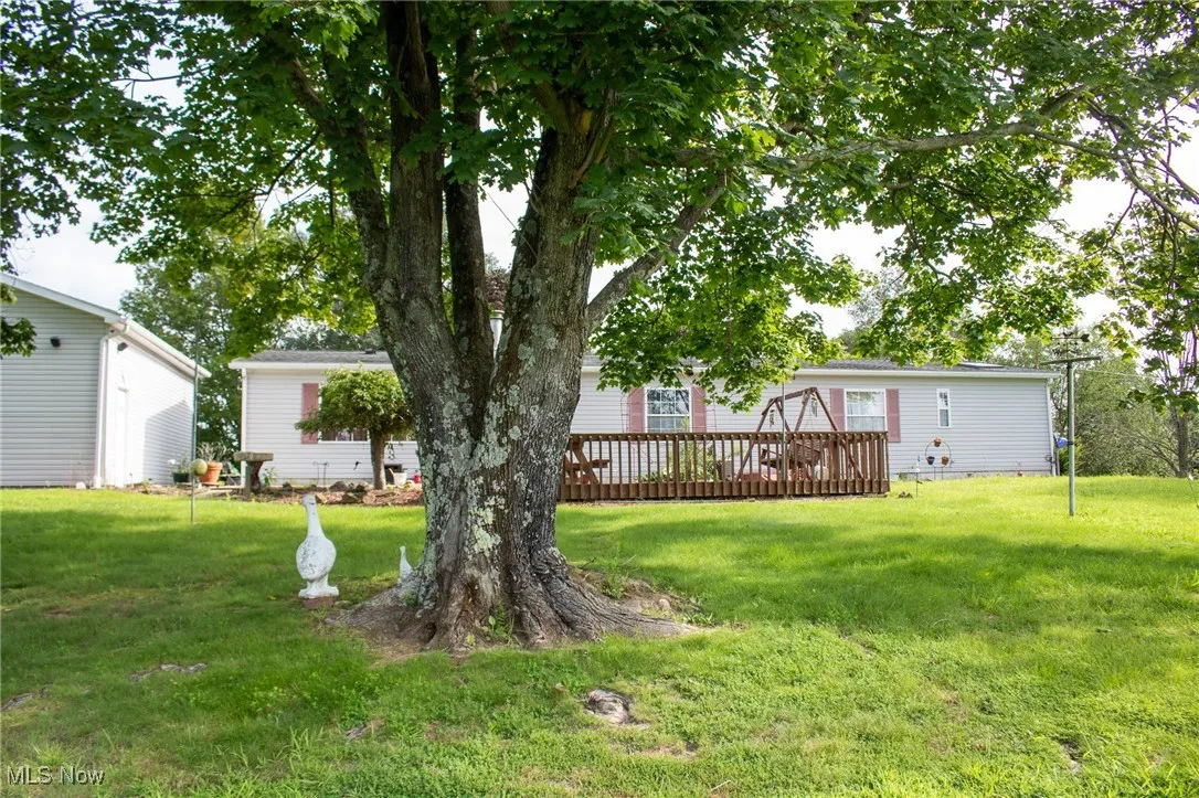 View of green lawn with a deck