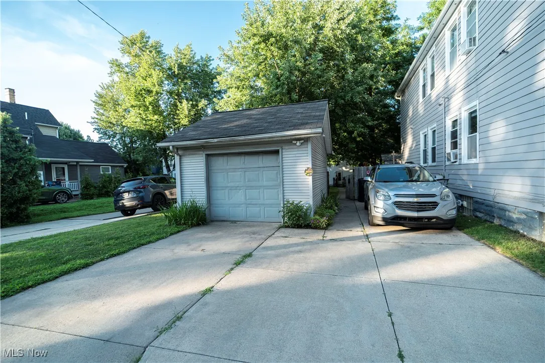 Garage featuring concrete driveway