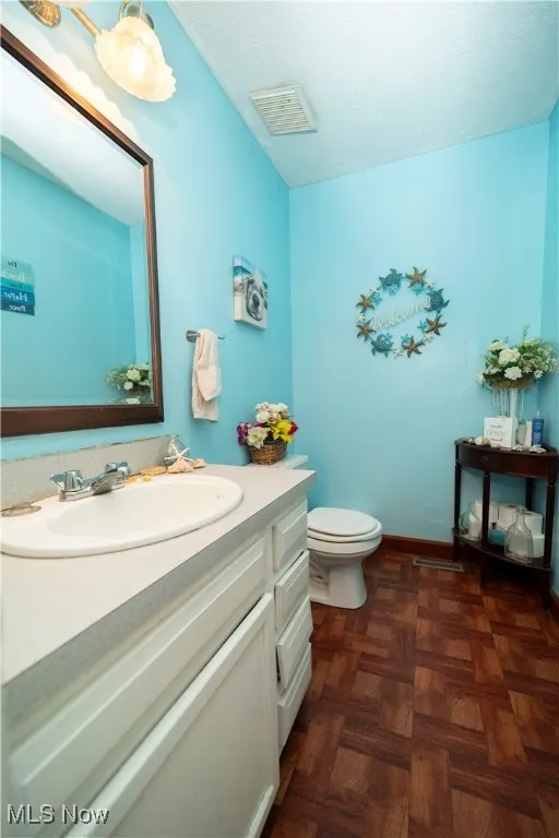 Half bath with vanity and​​‌​​​​‌​​‌‌​‌‌​​​‌‌​‌​‌​‌​​​‌​​ toilet