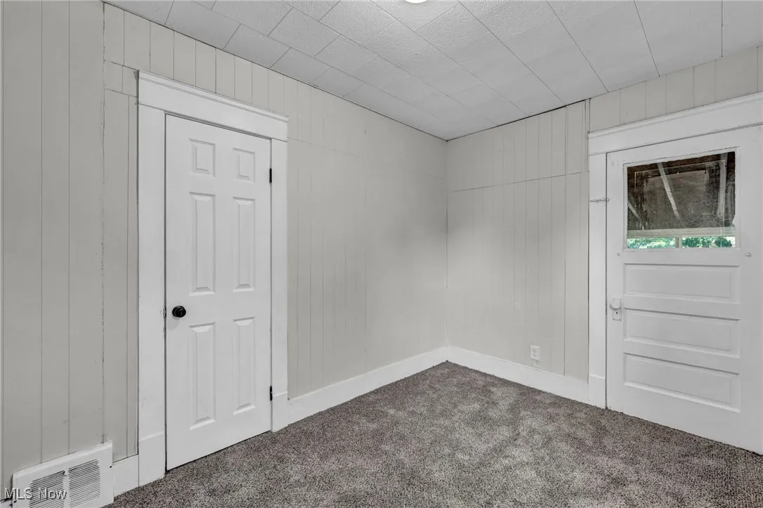 Bedroom with carpet and access to enclosed back porch