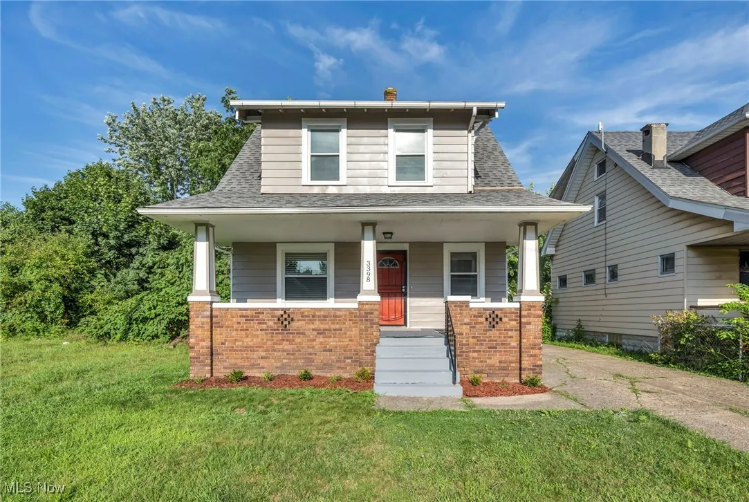 Colonial style home with brick covered porch, freshly painted exterior and brand new roof