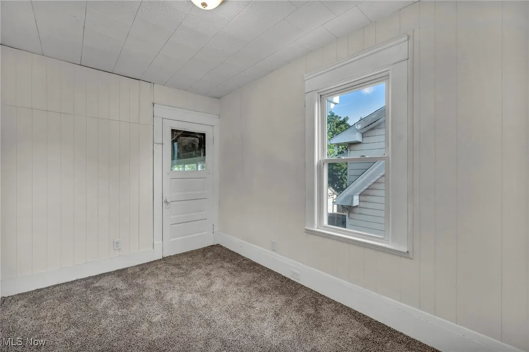 Bedroom with carpet and access to enclosed back porch