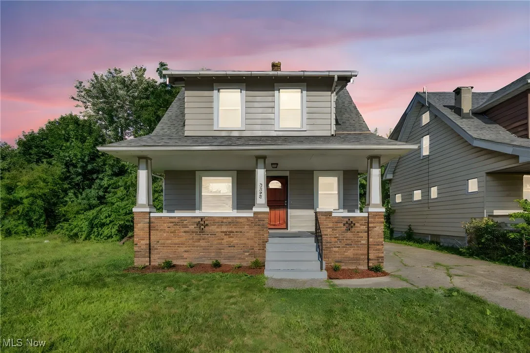 Colonial style home with brick covered porch, freshly painted exterior and brand new roof