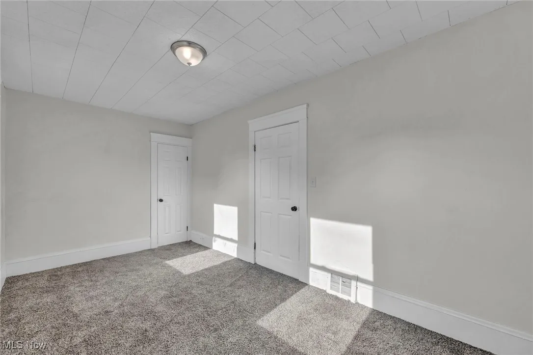 Bedroom with carpet and new windows
