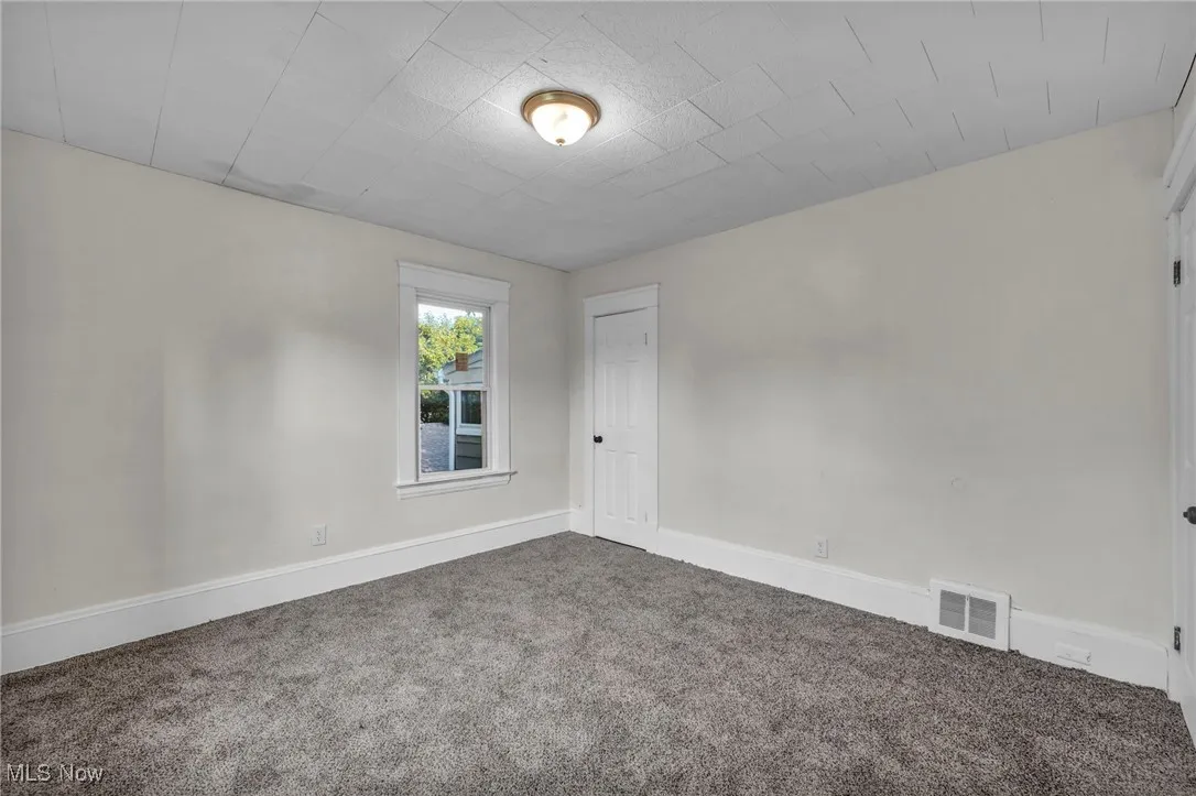 Bedroom with carpet and new windows
