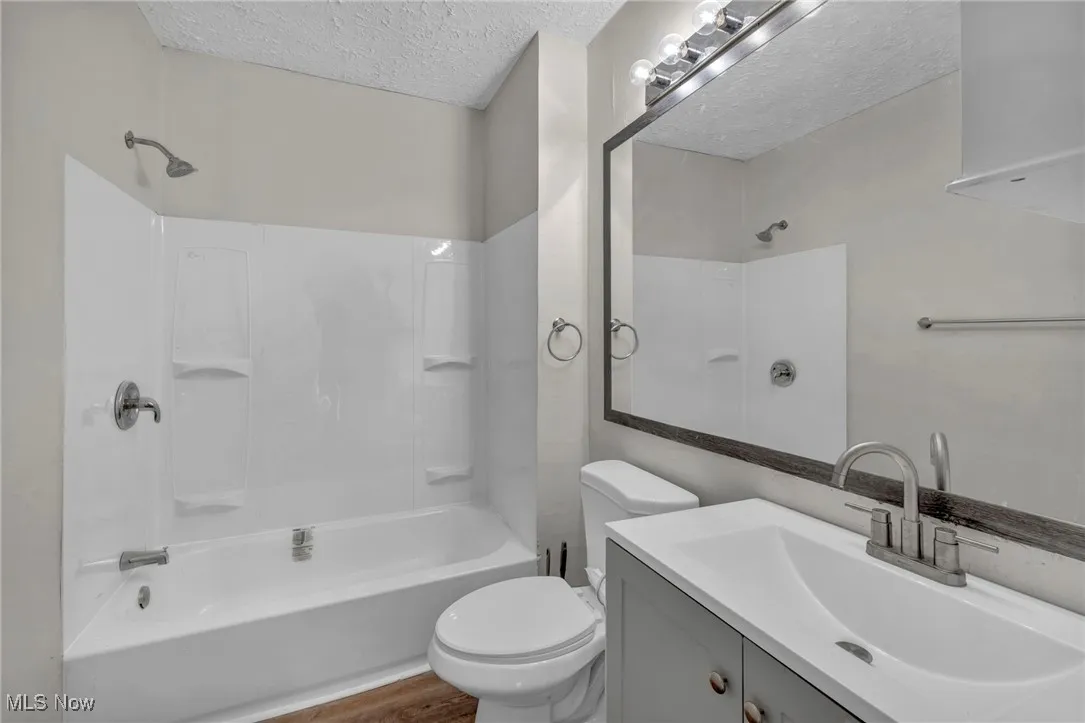 Bathroom tub and shower combination, new vanity, new lighting and mirror