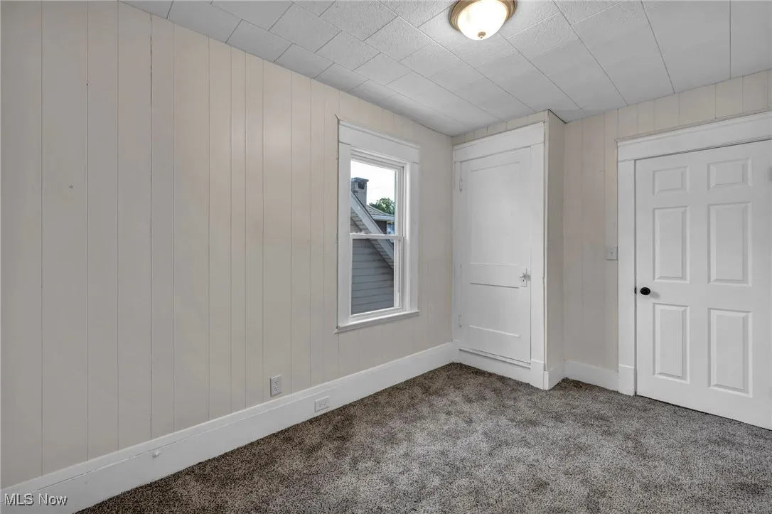 Bedroom with carpet and access to enclosed back porch