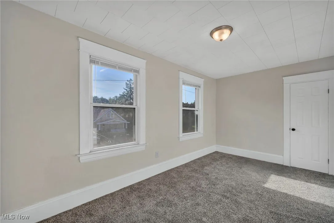Bedroom with carpet and new windows