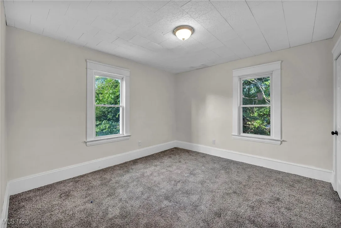 Bedroom with carpet and new windows