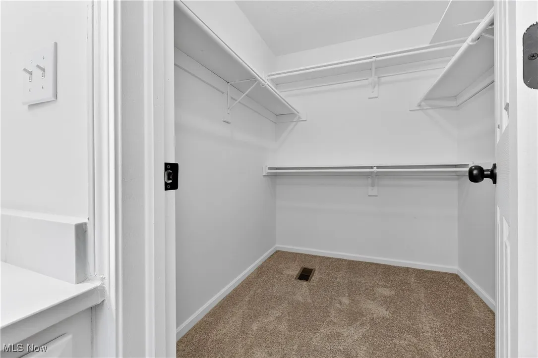 Primary bedroom walk in closet