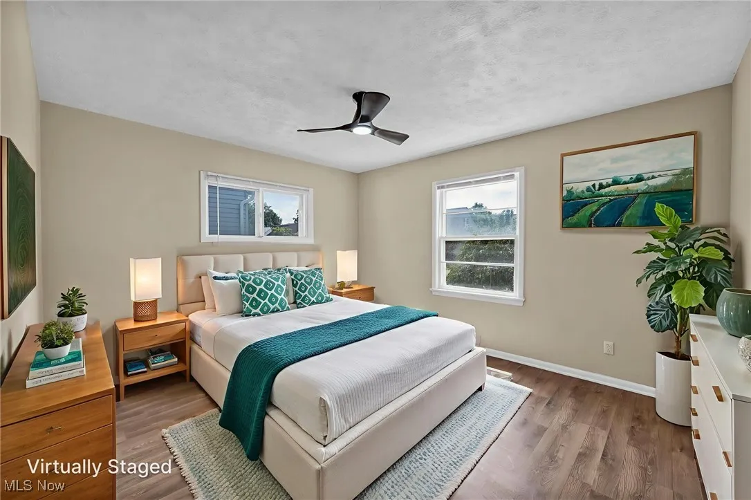 Bedroom featuring wood finished floors, a ceiling fan, and a textured ceiling