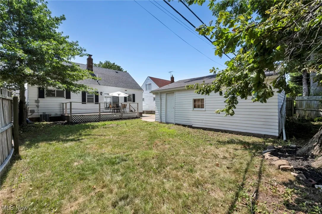 Fenced backyard with a deck and an outdoor structure