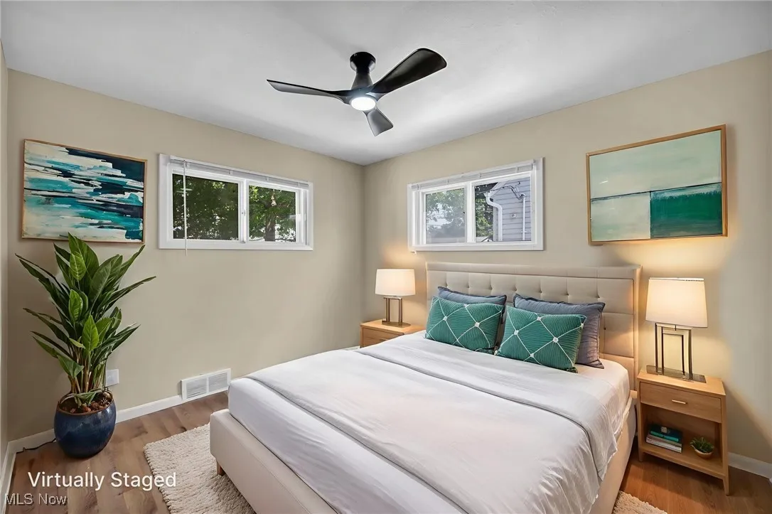 Bedroom with wood finished floors and ceiling fan