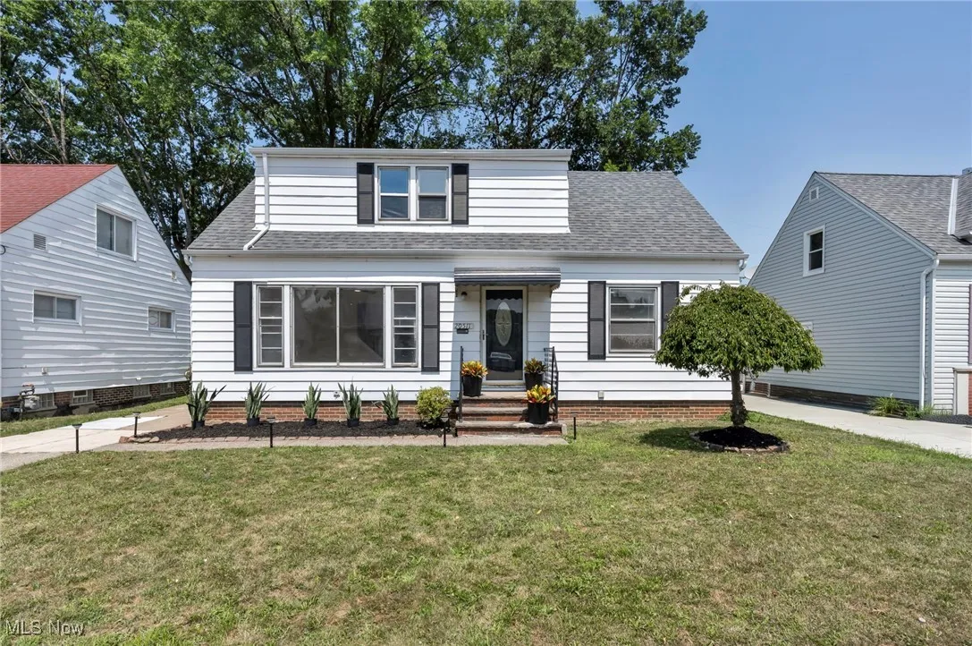 Bungalow-style house featuring a shingled roof and a front yard