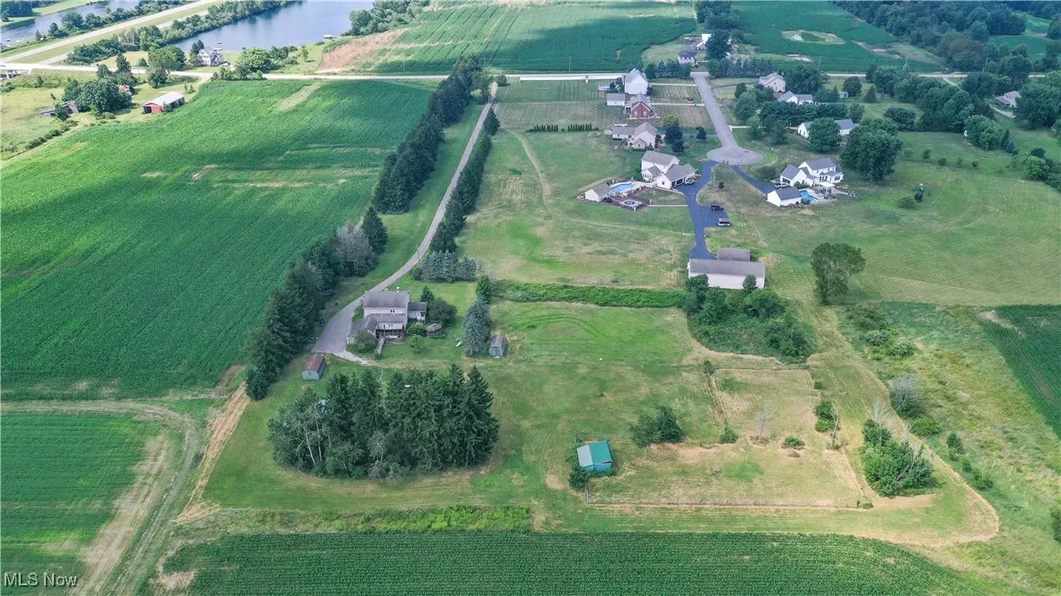 View of property location with rural landscape, a nearby body of water, and farmland