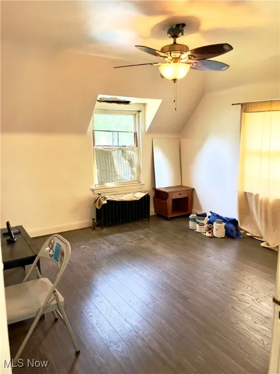 2nd bedroom featuring radiator heating unit, hardwood / wood-style floors, ceiling fan, and lofted ceiling