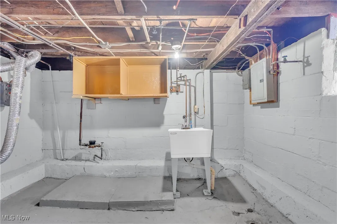Unfinished below grade area with electric panel