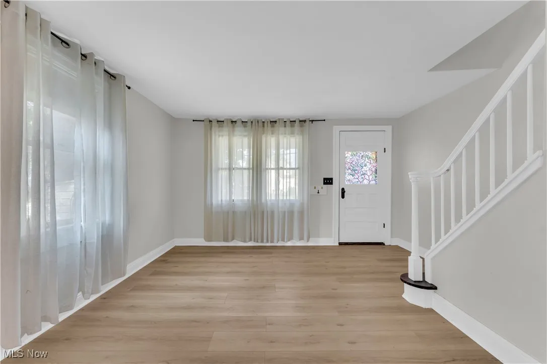 Foyer featuring light wood-type flooring and stairs