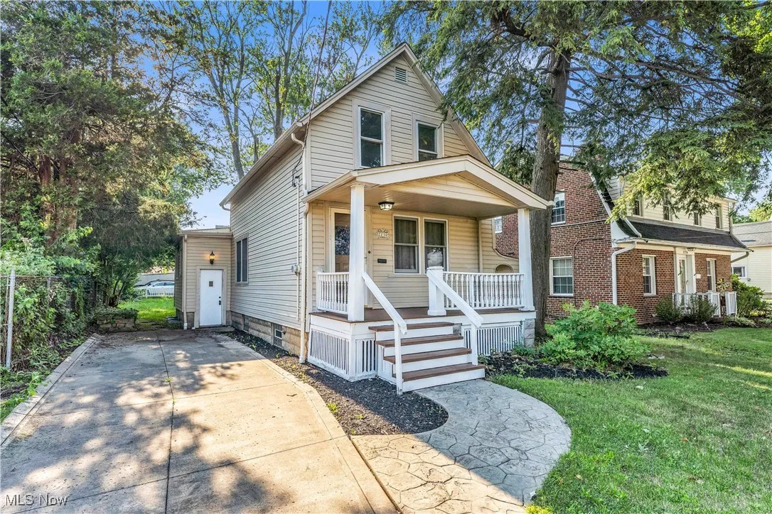 View of front of home with covered porch, a front yard, concrete driveway, and crawl space