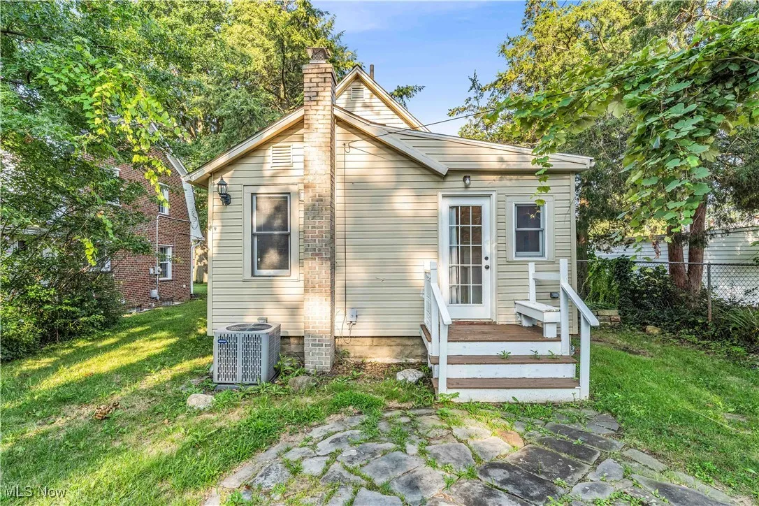 Rear view of property featuring a chimney