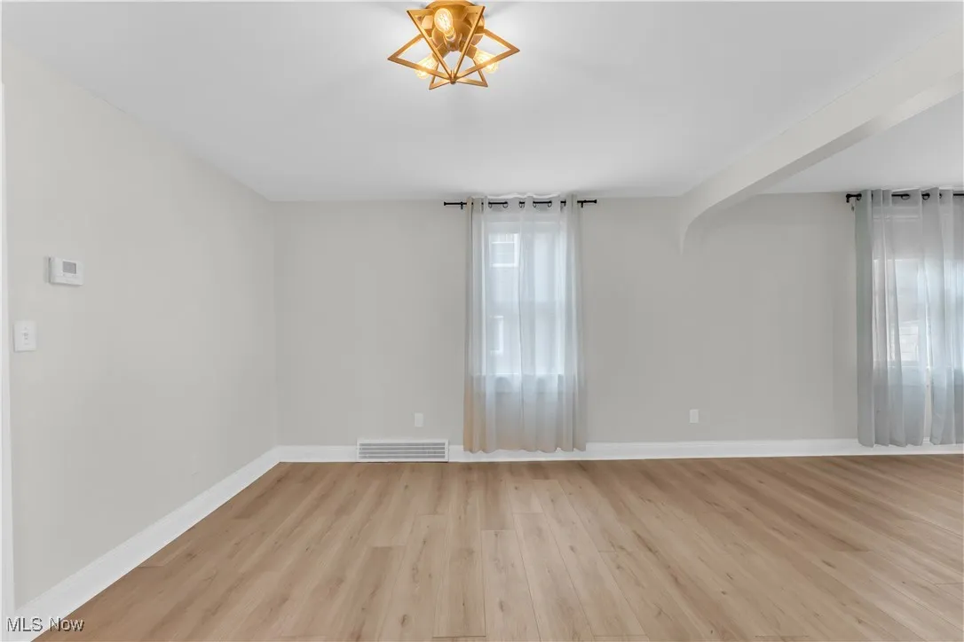 Empty room featuring light wood-type flooring and baseboards