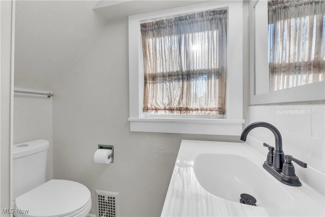 Half bathroom featuring toilet and a sink