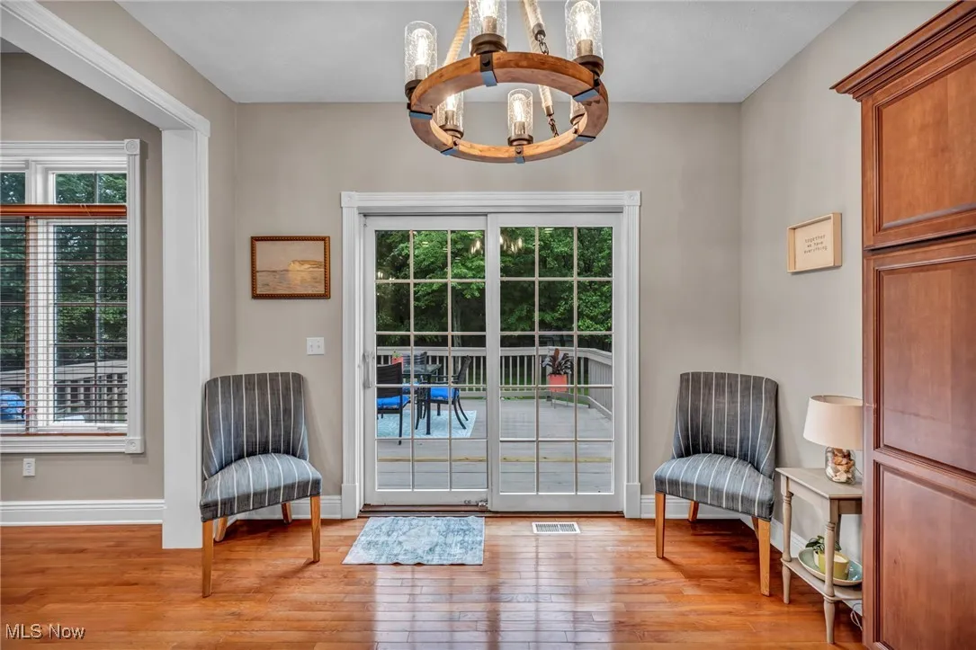 Doorway featuring a chandelier and light wood-type flooring