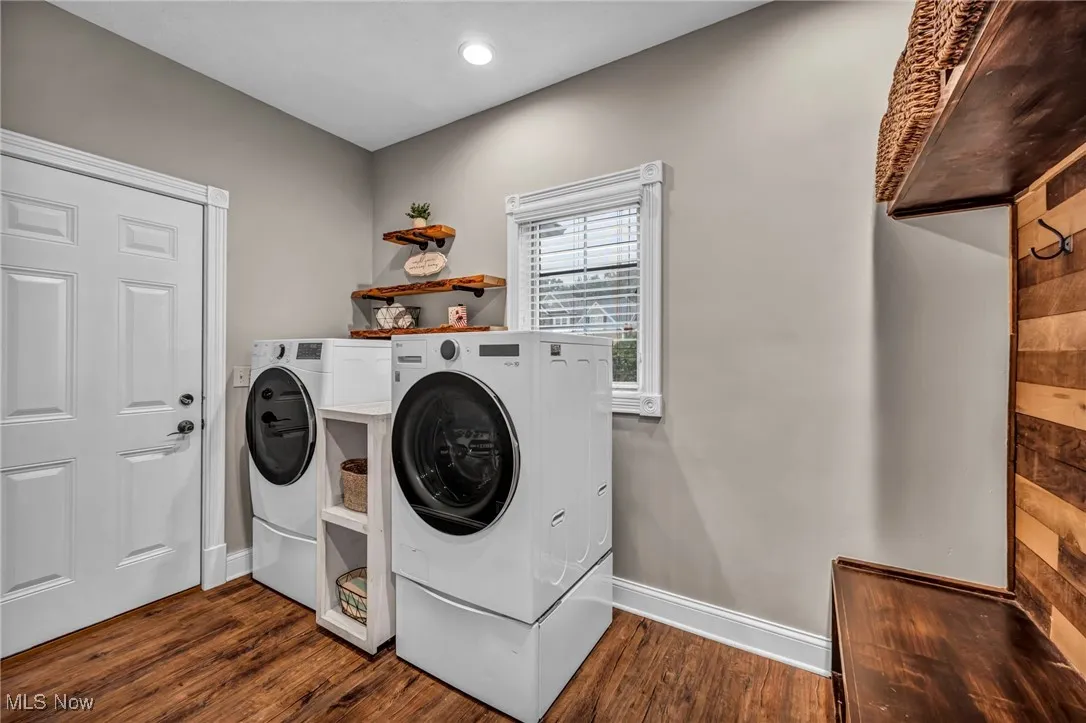 Laundry area featuring separate washer and dryer, dark wood-style flooring, and recessed lighting