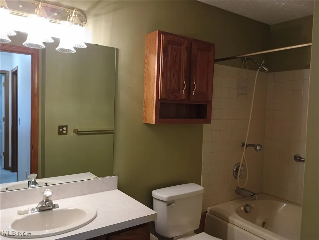 Bathroom with vanity and bathtub / shower combination