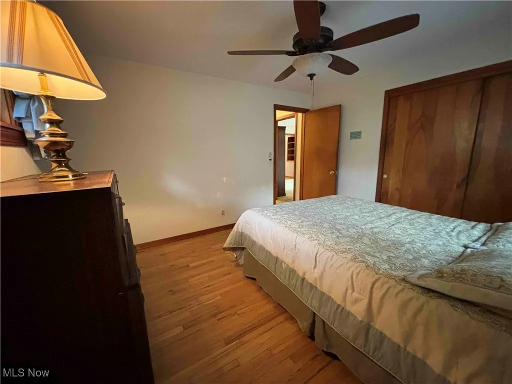 Bedroom with light wood-type flooring and a ceiling fan