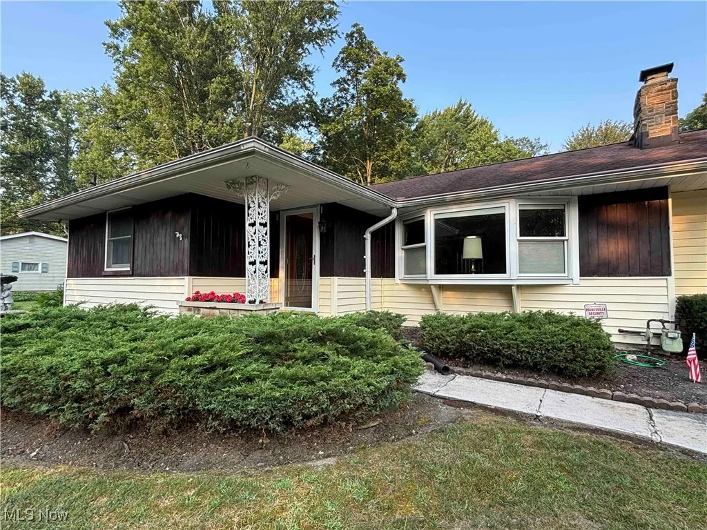 View of front of property featuring a chimney