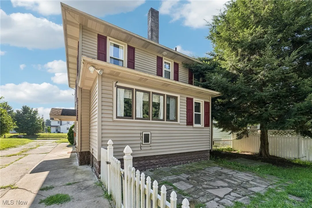 View of property exterior featuring a chimney