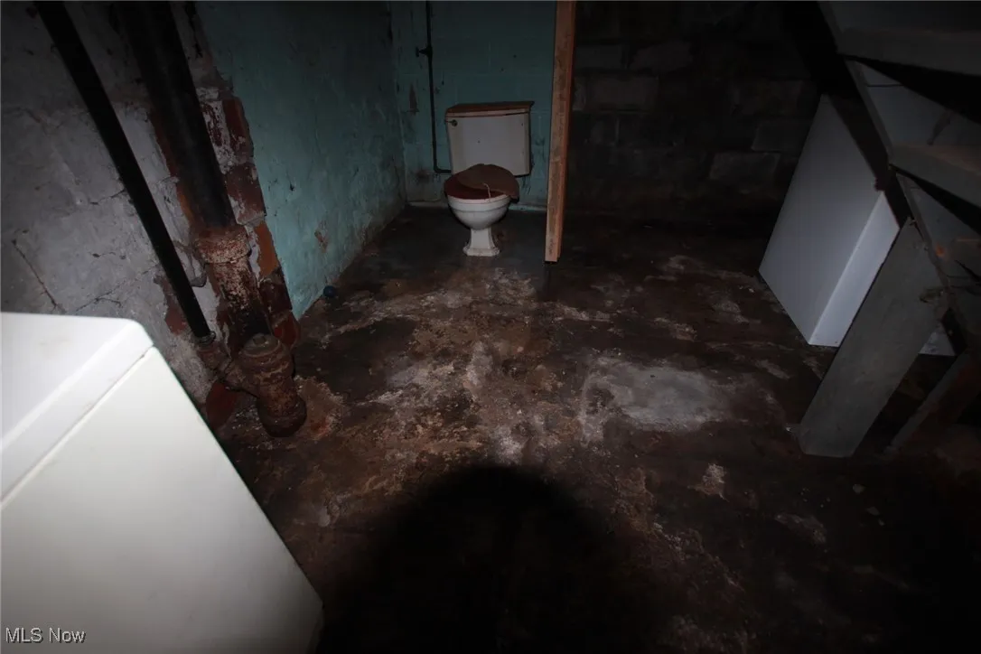 Bathroom featuring washer / clothes dryer and concrete floors