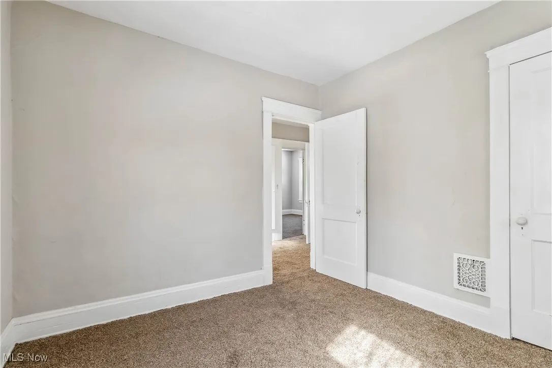 Unfurnished bedroom featuring carpet, visible vents, and baseboards