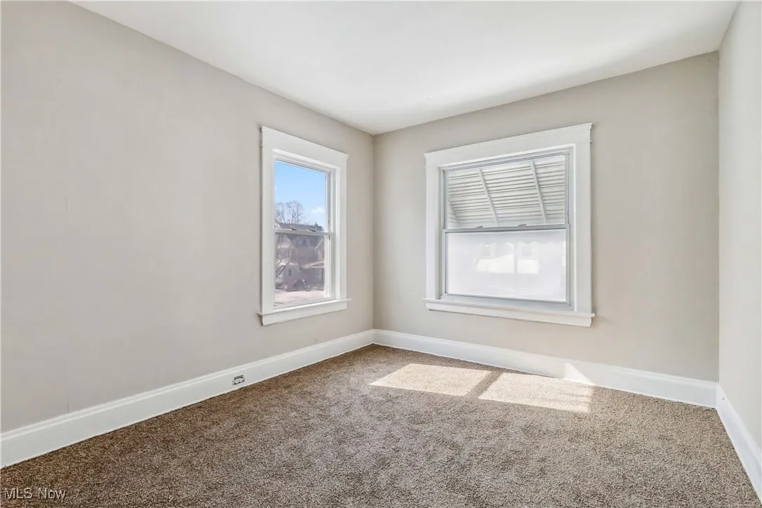 Empty room featuring carpet floors and baseboards