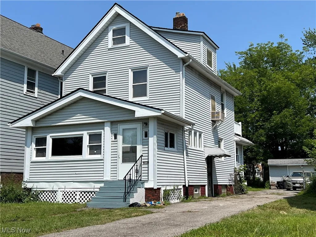 View of front of property with entry steps and a chimney