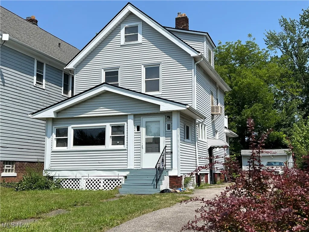 View of front of house with entry steps and a chimney
