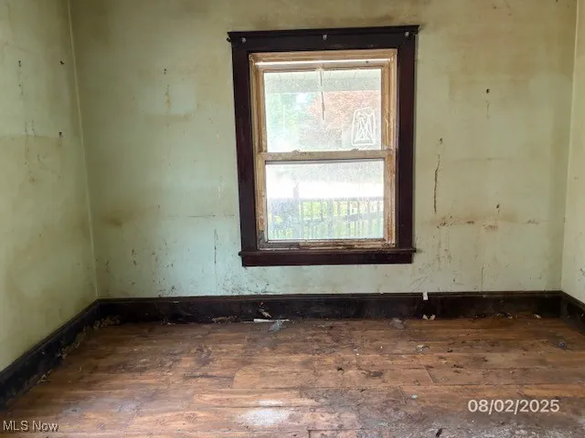 Unfurnished room with wood-type flooring