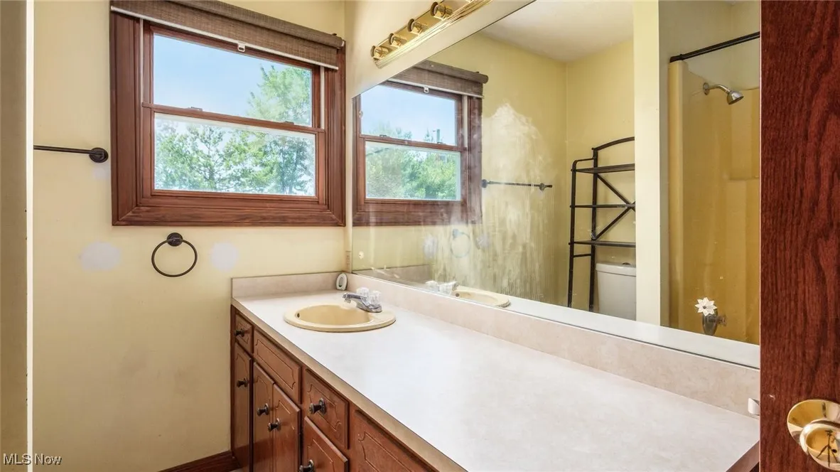 Bathroom featuring vanity and a shower